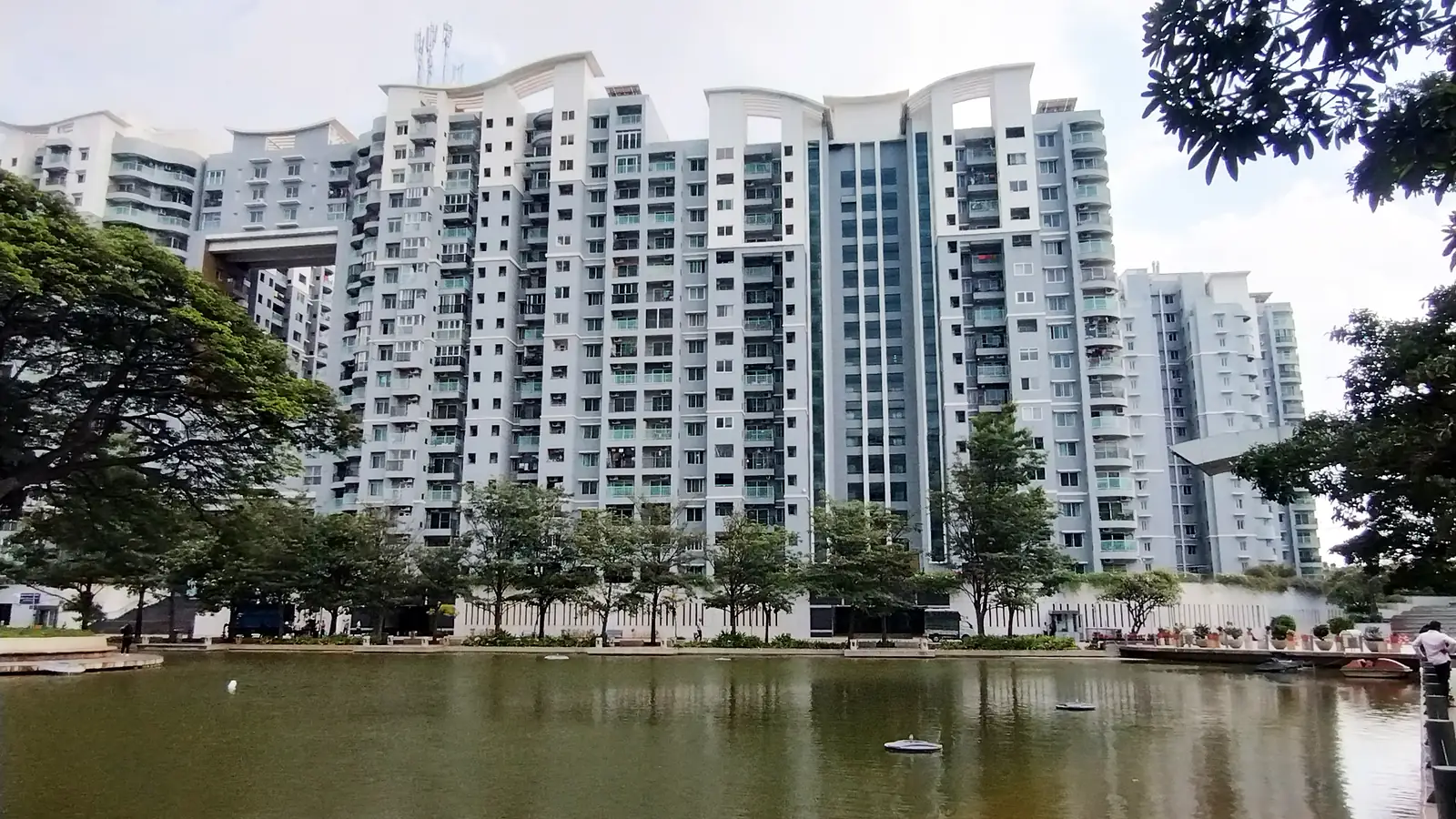 Apartment blocks near Rajajinagar, Bengaluru, seen across a water body under a clear sky